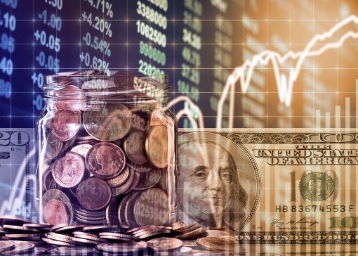 Gold coins in clear bottle and american dollars money over the LED display Stock market exchange data background, Business investment and trading concept